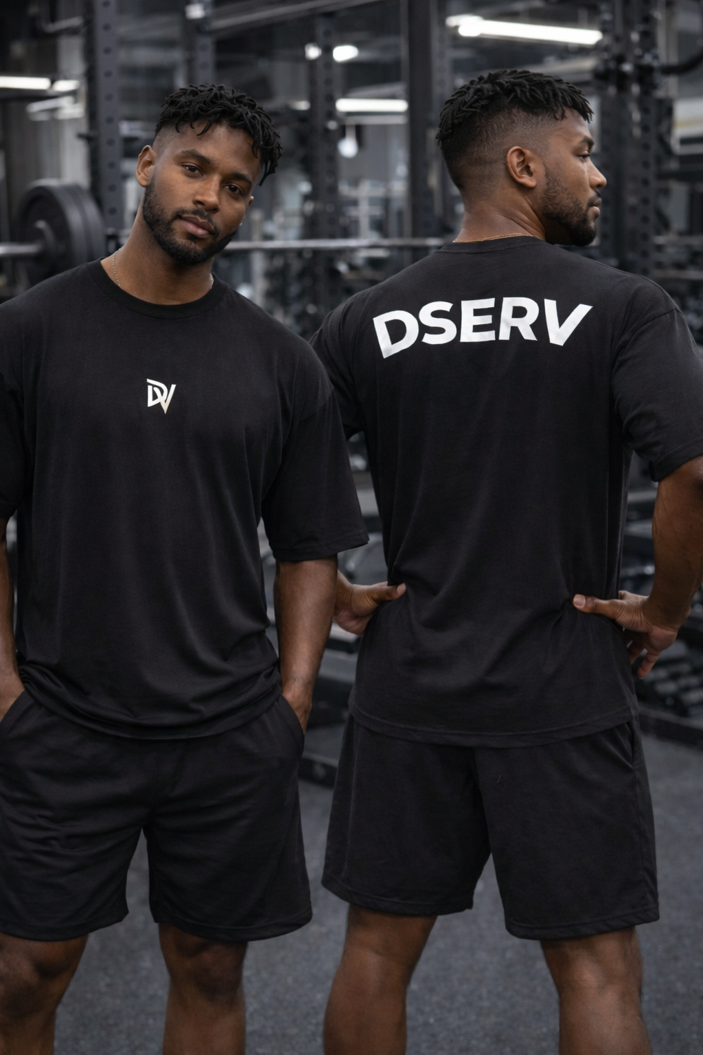 Two men wearing black athletic wear with visible branding in a gym setting