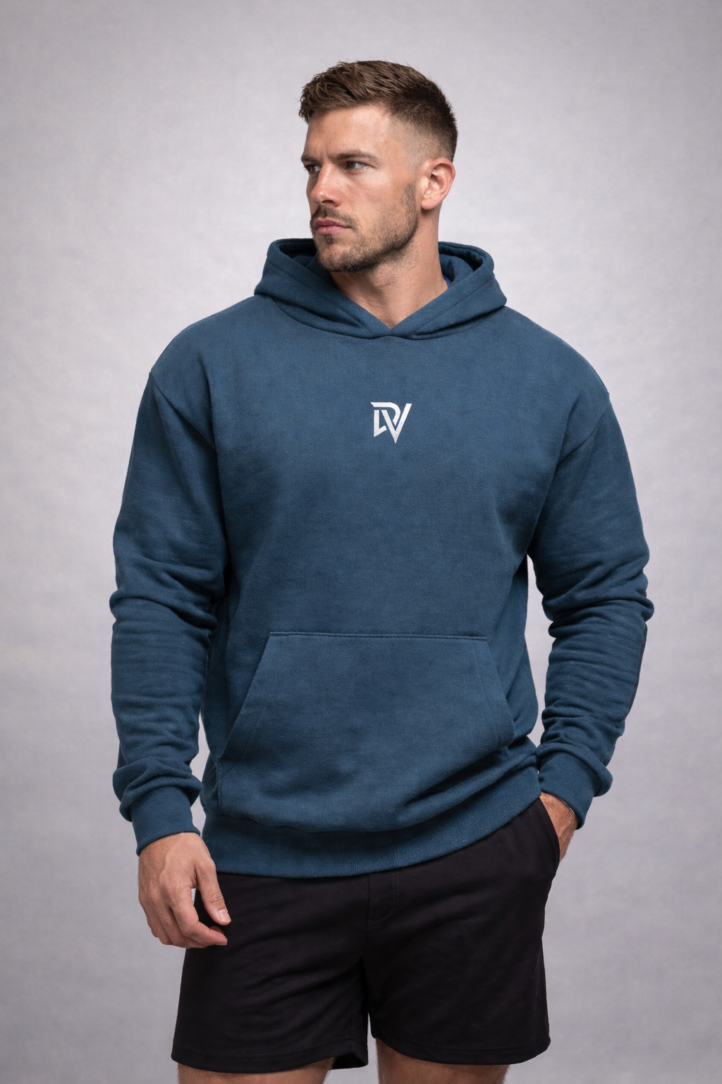 Man wearing an Airforce blue hoodie with a logo on a gray background