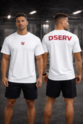 Two men wearing white t-shirts with red text, one facing front and one facing back, in a gym setting.
