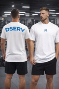 Man wearing a white t-shirt with 'DSERV' branding on the back, standing in a gym.