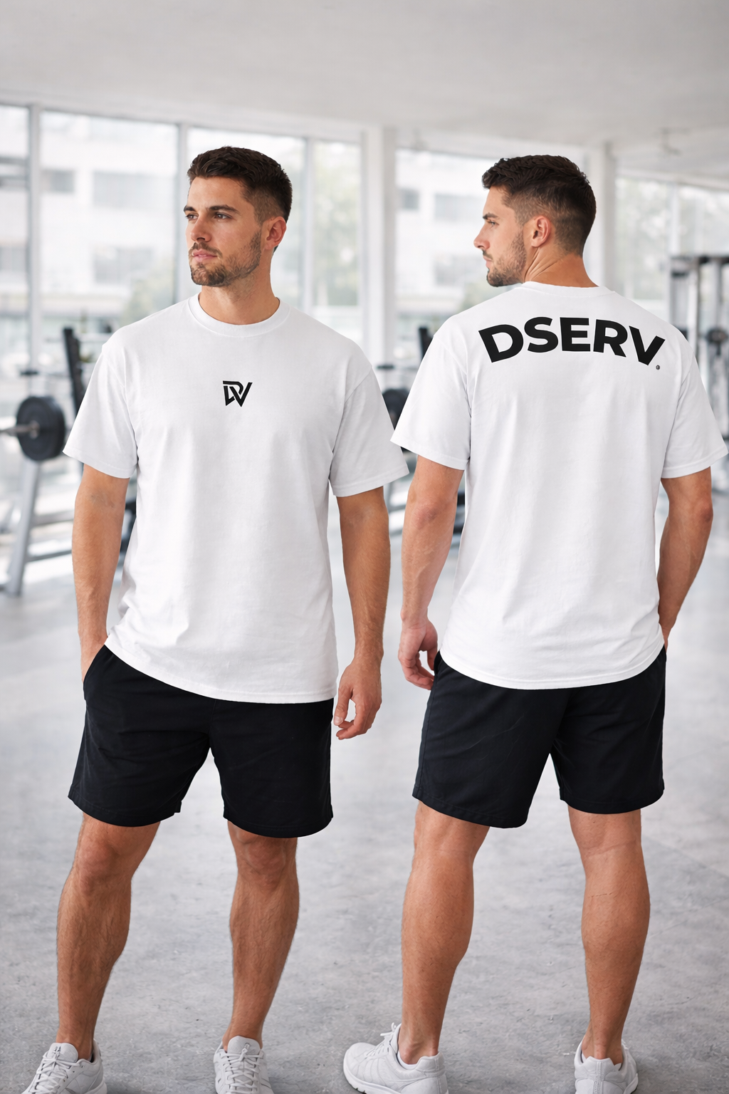 Two men wearing white t-shirts with logos, one facing forward and one facing backward, in a gym setting.