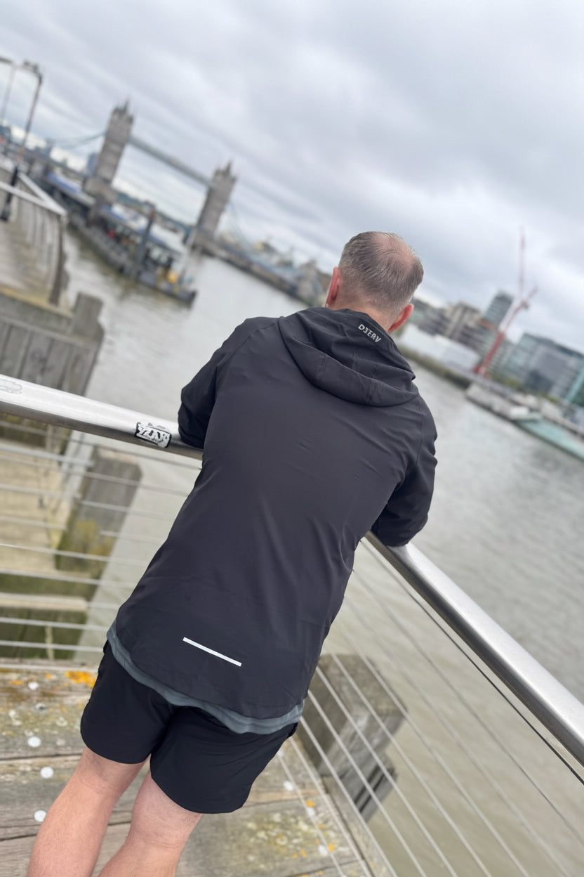 Person stretching on a bridge with Tower Bridge in the background